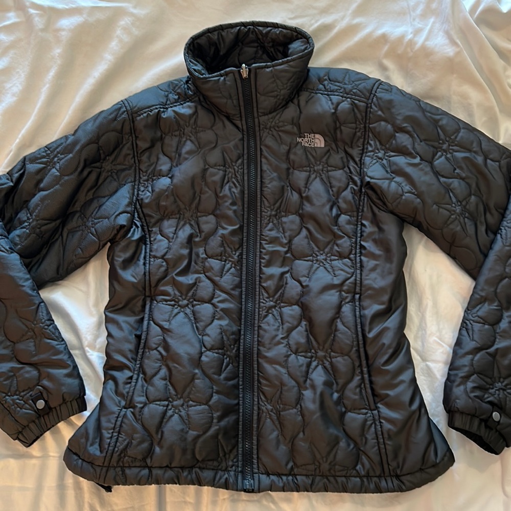 Black North Face women’s jacket with patterned stitching